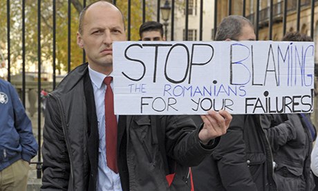 Image of protest. Placard reads 'Stop blaming the Romanians for your failures!"