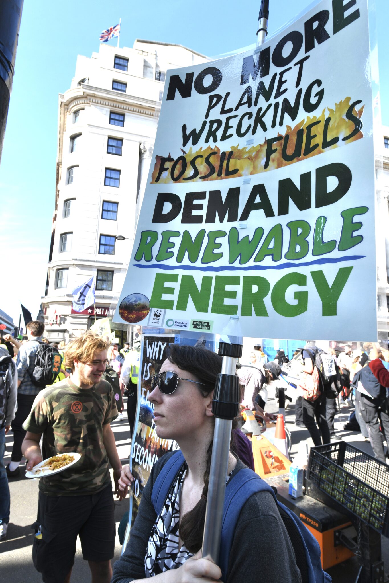 Extinction Rebellion protest, banner reads NO MORE PLANET WRECKING FOSSIL FUELS DEMAND RENEWABLE ENERGY