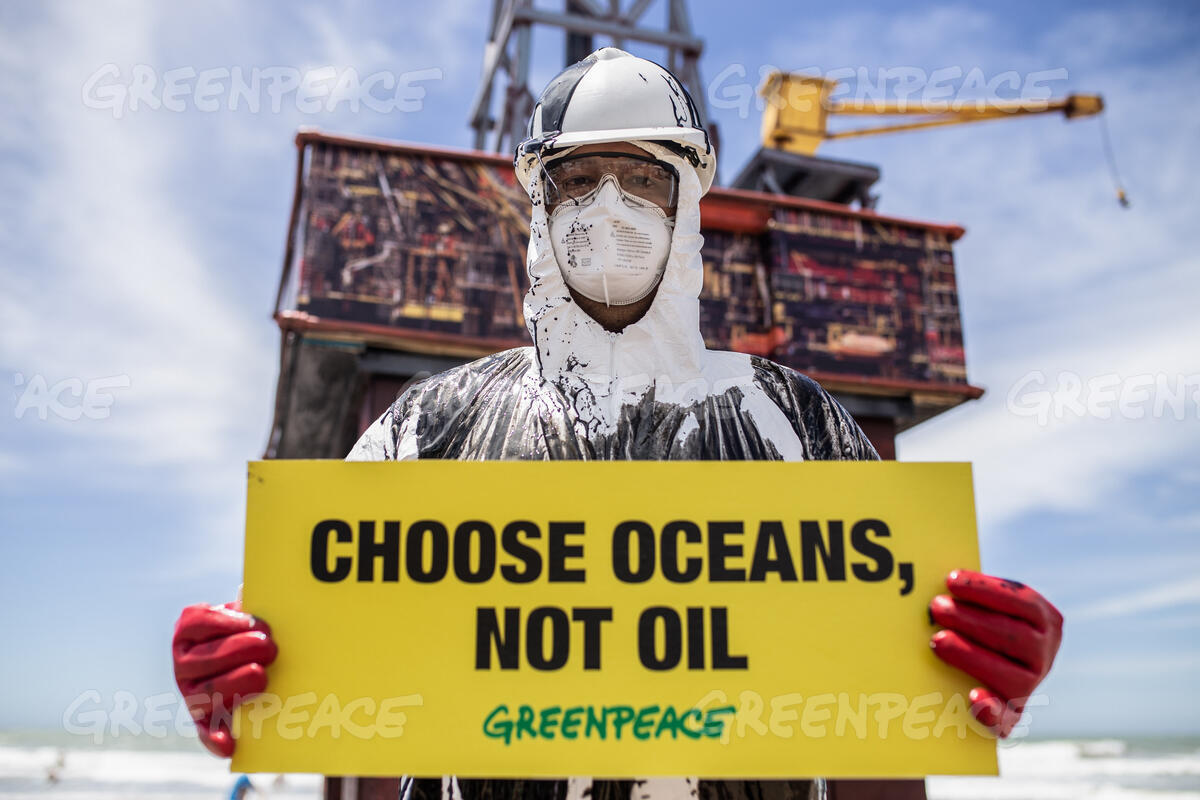 Greenpeace image, sign reads CHOOSE OCEANS, NOT OIL