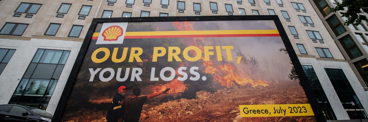 Greenpeace activists display a billboard during a protest outside Shell headquarters on July 27, 2023 in London.