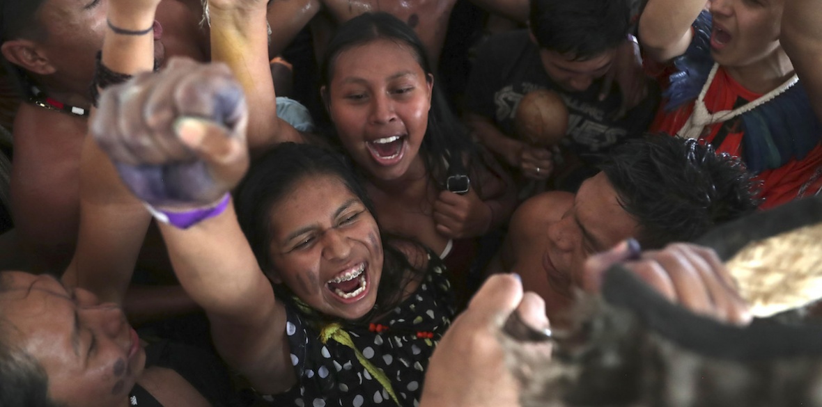 Indigenous people celebrate a Supreme Court ruling to enshrine Indigenous land rights, in Brasilia, Brazil, Thursday, Sept. 21, 2023.