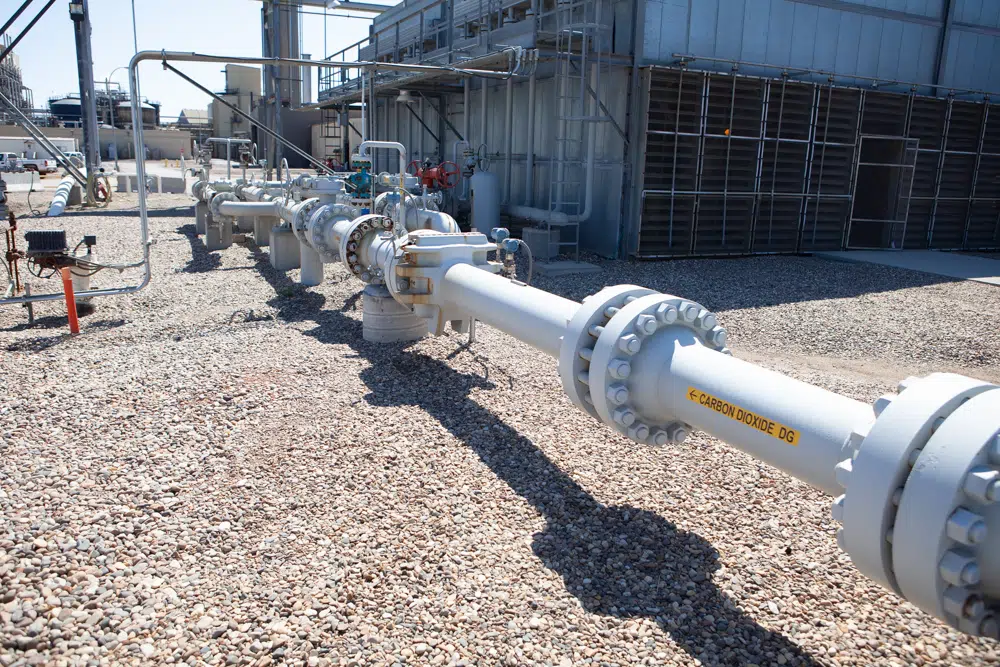 Carbon dioxide runs through pipes at a North Dakota CCS plant. Credit: Buchsbaum Media.