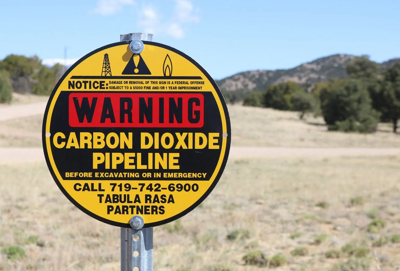 A metal sign warning of a buried carbon dioxide pipeline in Huerfano County, Colorado. Credit: Jeffre Beall, CC BY 4.0